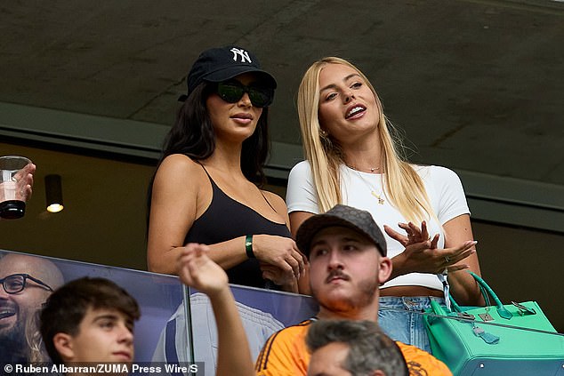 Kim watched the football match from a suite