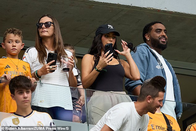 She was seen taking pictures of son Saint on the field