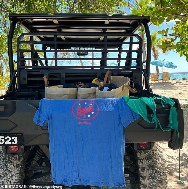 She also shared a photo of a 'Sex' T-shirt and her green bikini spread out on the back of a beach buggy on the beach