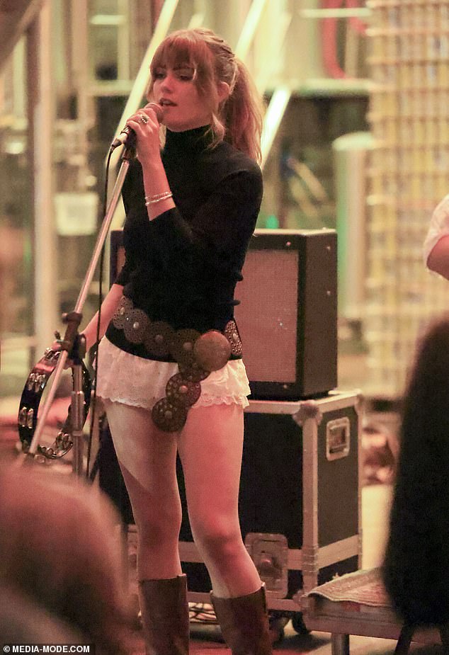 The performer completed her look with a bronze concho belt as she sang and played tambourine for the crowd that had gathered for the performance