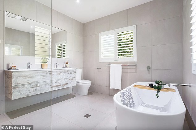 The house was built in the 80's and is just 100 metres walk from the ocean and Byron's famous Tallow Beach. Pictured: one of the two bathrooms