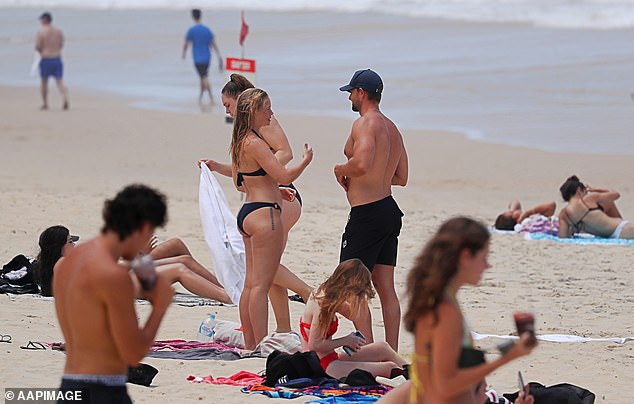 Northern Australia is set to remain warm with Brisbane expected to experience its hottest day in August later this week - 34C (photo from a stock photo of people on a beach in Queensland)