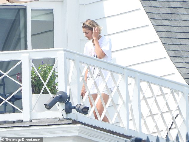 The 29-year-old supermodel, who is best friends with the It Ends With Us star and Swift, 34, looked fresh-faced as she appeared on a balcony at the house - days after her boyfriend Bradley Cooper was spotted at the house