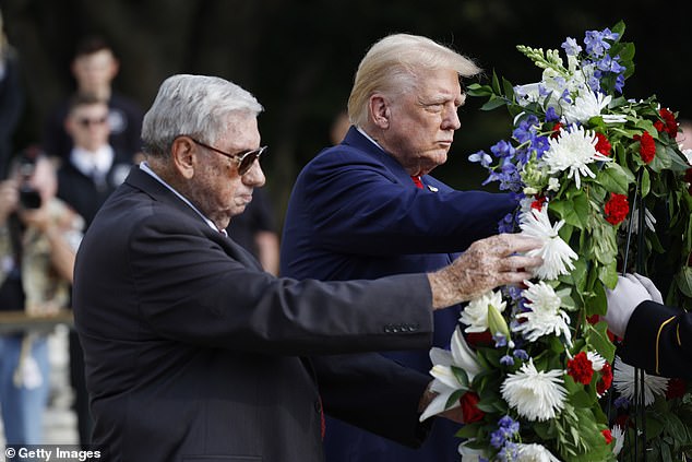 Trump stands next to Bill Barnett (left), whose grandson Staff Sgt Darin Taylor Hoover was killed in the Abbey Gate bombing in Kabul, Afghanistan, during a wreath-laying ceremony at the Tomb of the Unknown Soldier at Arlington National Cemetery