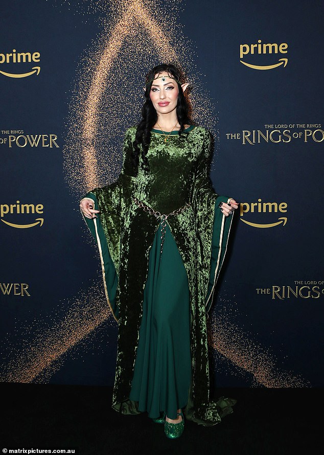 Dani Dacic opted for a mesmerizing emerald green velvet dress with flowing sleeves, complemented by elf-inspired accessories