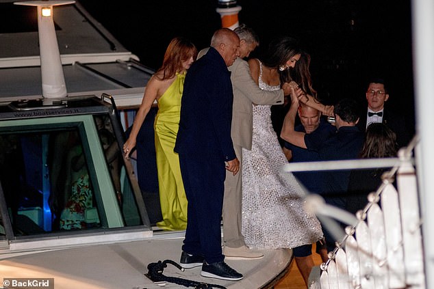 Amal and George were joined by friends as they stepped off the boat