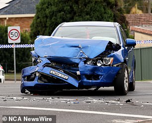 A blue sedan with the front completely destroyed