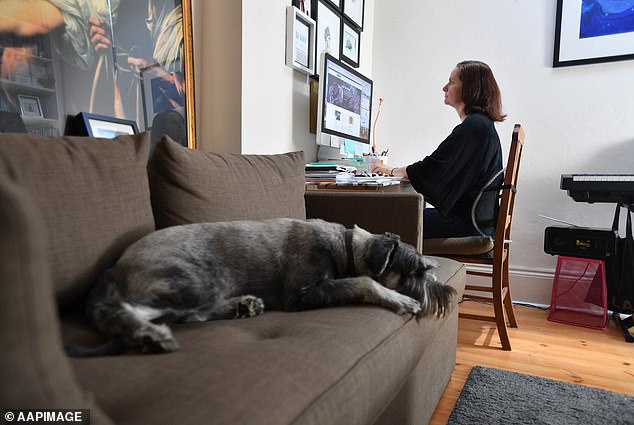 Fewer Australians are now embracing working from home in regional areas as building permits fall outside capital cities, new data shows (pictured is an Adelaide professional)