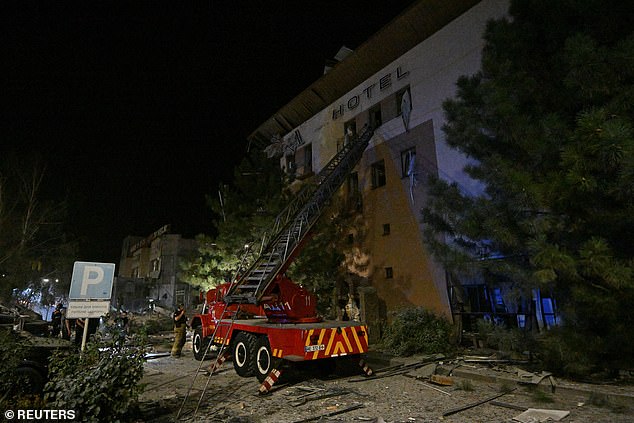 An emergency vehicle is seen next to the building where at least two people were killed last night