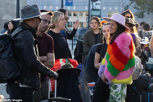 The festival, which combines wilderness camping with a week of celebrating art for art's sake, kicked off early Sunday morning after gates were closed for 12 hours due to rain and muddy conditions.