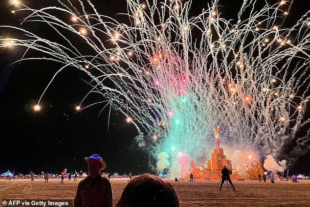 A security guard keeps people at a distance during the annual Burning Man Festival on September 4, 2023