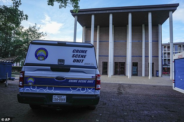 A police unit vehicle is parked after the suspected murder-suicide on Monday