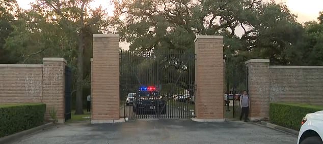 A police car is parked outside the university entrance. There were no signs of forced entry into the room.