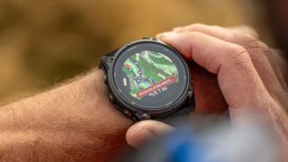 Garmin Enduro 3 watch on the wrist of a tattooed man