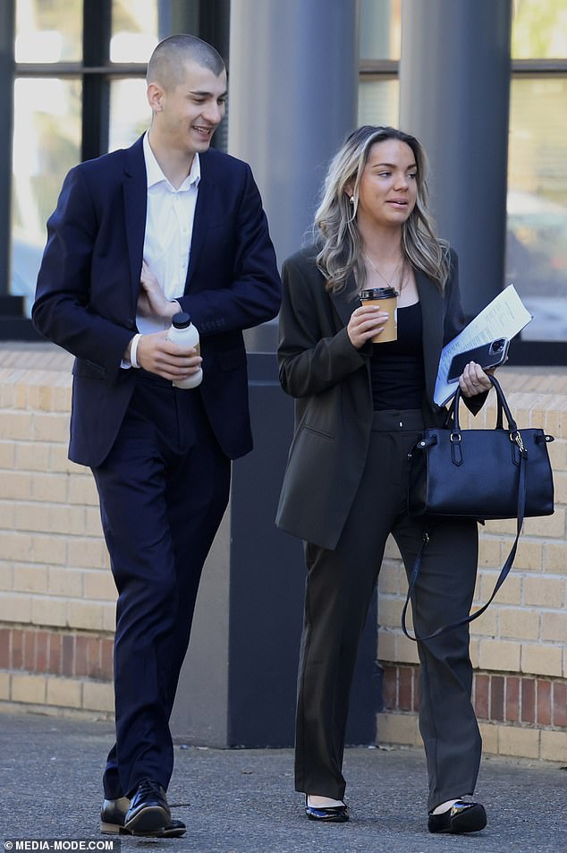 Chris Corrig and his lawyer arrive at Burwood District Court on Tuesday where his bail was changed on charges including praying a Nazi swastika on a statue at Macquarie University