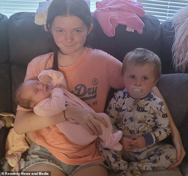 Poppy and Jake are pictured with their new baby sister Hayley, who was born during their family camping holiday