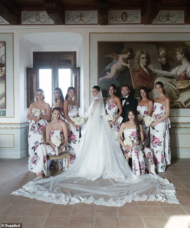 Her eight bridesmaids (all pictured) looked stunning in strapless Aveline gowns, each worth $1,299, which featured a white base adorned with pink floral patterns.