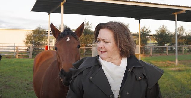 Despite her attempts to bravely continue her speech, the horse refused to be ignored as it rubbed against Mrs. Rinehart's back