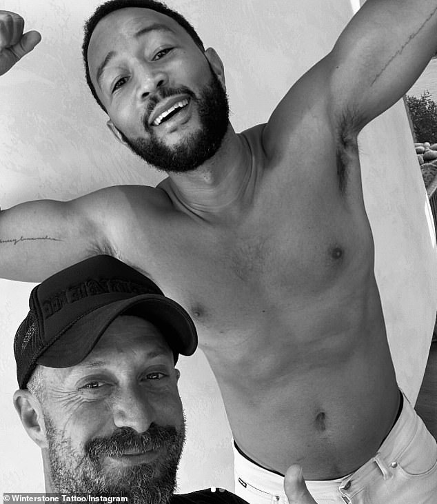 He posed shirtless next to tattoo artist Winterstone (L)