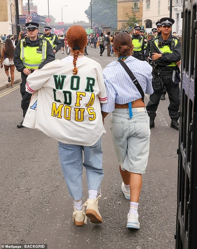 The 39-year-old TV presenter and the singer looked every inch the happy couple as they strolled hand in hand through the streets during the annual event