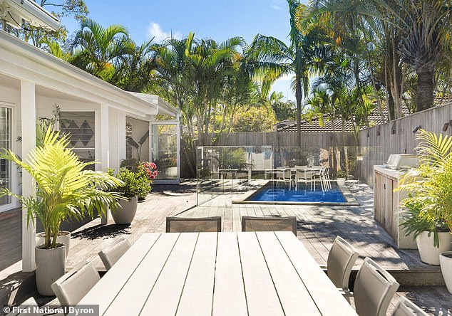 Situated just 6km from the centre of Byron Bay and just minutes from the famous Tallow Beach, the home has been designed to make the most of its tropical surroundings. Pictured; The pool and BBQ area