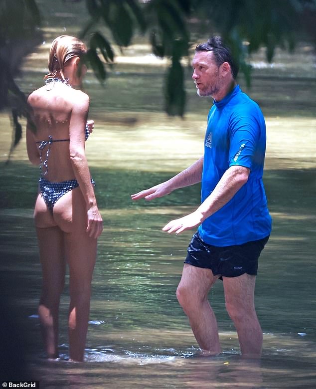 Lara's swimsuit made the most of the blonde bombshell's ultra-slim figure. Pictured with husband Sam