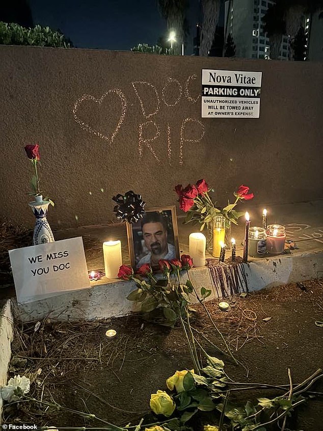 Patients and friends have created a memorial outside the clinic with red roses, candles, photos and a sign that reads 'we miss you, doctor'