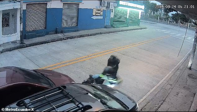 Two robbery suspects are pushed off their motorcycle as a Good Samaritan came to the aid of a woman after she was forced to hand over her cell phone, Saturday in Guayaquil, Ecuador