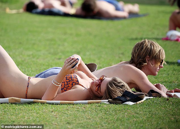 Mia enjoyed the sun while lying on her beach towel