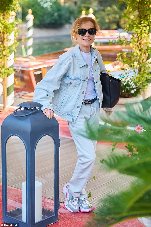 Elsewhere, Isabelle Huppert (pictured) stunned in a stylish double denim look as she joined Patti Smith at the festival