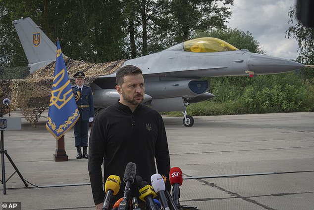 Ukrainian President Volodymyr Zelenskyy answers questions from the media against the backdrop of the Ukrainian Air Force's F-16 fighter jets on August 4