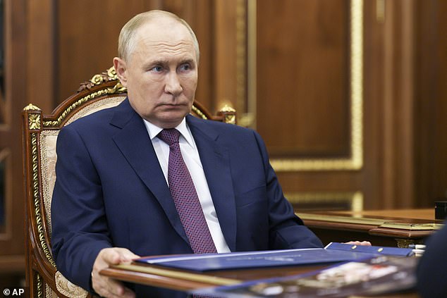 Russian President Vladimir Putin listens to Astrakhan Region Governor Igor Babushkin during their meeting at the Kremlin in Moscow, Russia, Tuesday, August 27.