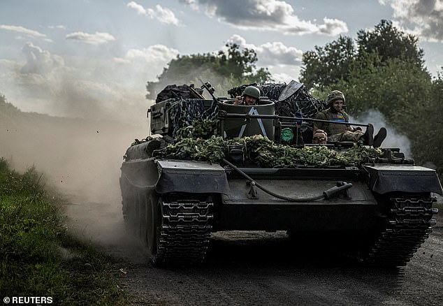 Ukrainian soldiers ride in a military vehicle, during the Russian attack on Ukraine, near the Russian border in the Sumy region, Ukraine, August 11, 2024