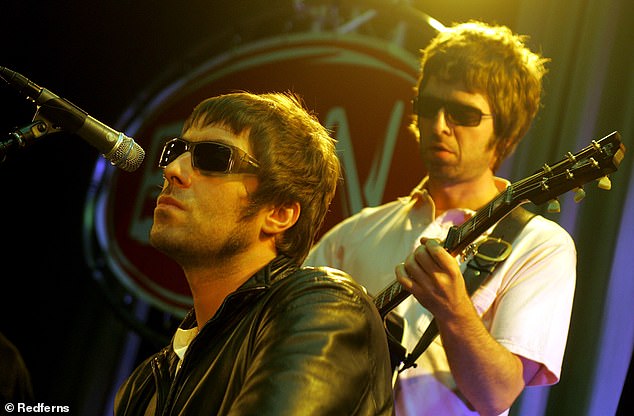 Liam Gallagher and Noel Gallagher are pictured performing live on stage in 2001