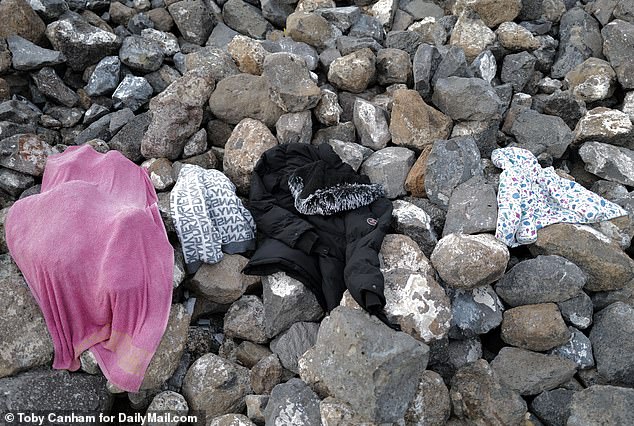 Clothing - including children's clothing - discarded by migrants on the American side of the wall