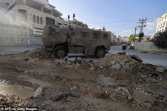 An Israeli military vehicle drives on a road during a raid in the northern town of Tulkarm in the occupied West Bank on August 28, 2024