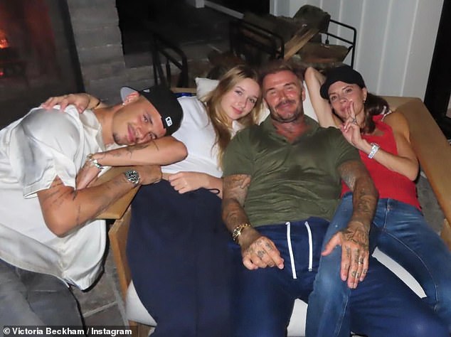 Another photo showed her and David relaxing on a couch with Harper and Romeo as they all beamed at the camera