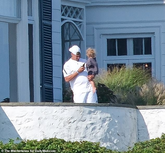 Mahomes was seen holding his son Bronze, 1, as he stepped out onto the mansion's expansive balcony overlooking the ocean