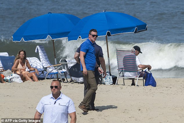 Secret Service agents surround President Biden as he enjoys some time at the beach