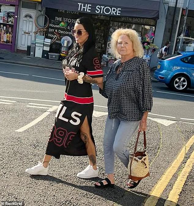 The mother and daughter looked cheerful after their trip to the salon, as they walked outside arm in arm and crossed a road