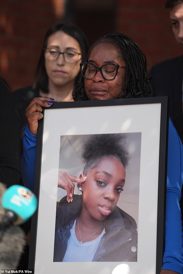 Earlier this month, a coroner noted that 'neither Hannah nor her mother had an epi-pen with them as prescribed' on the day she died. Hannah's mother, Abimbola Duyile, is pictured holding a photo of her daughter outside East London Coroner's Court earlier this month