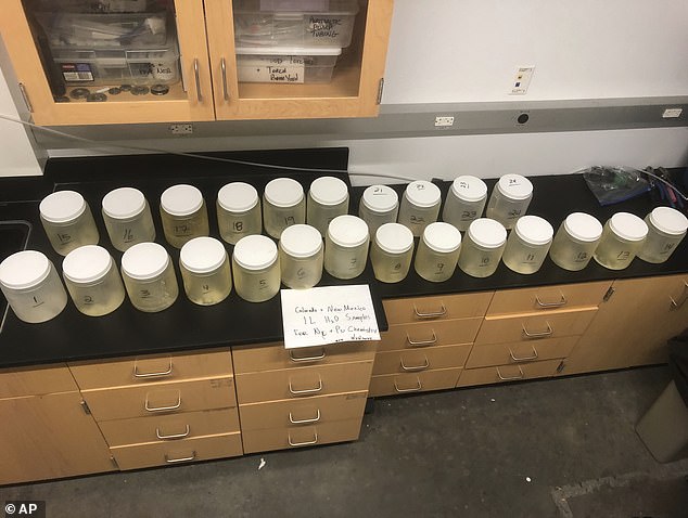 This July 22, 2024, image provided by biochemist Michael Ketterer shows jars containing water samples from Acid Canyon in Los Alamos, New Mexico