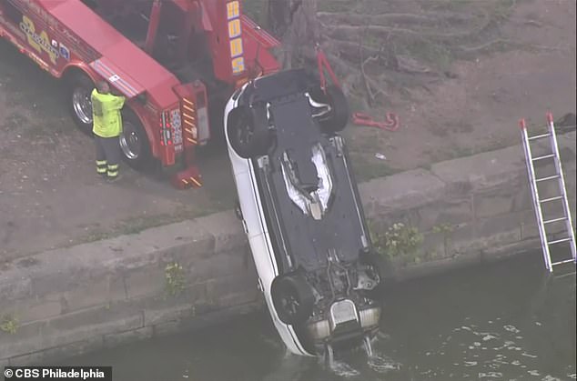 The white Range Rover was finally pulled from the river around 9am