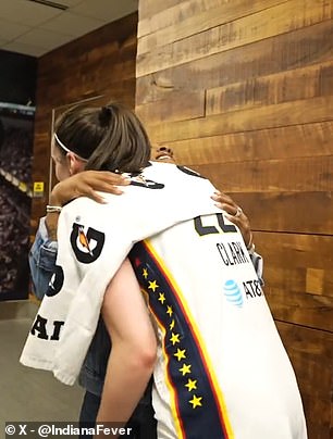 Clark and Biles share a hug in the Fever locker room