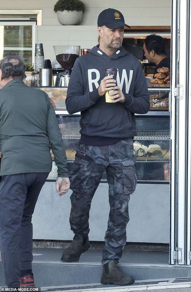 He looked casual in gray camouflage cargo pants and a black hoodie, which he paired with a pair of chunky Chelsea boots