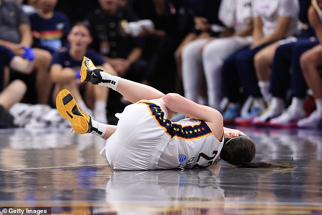 Clark lies on the field after being bodychecked by Connecticut Sun center Thomas