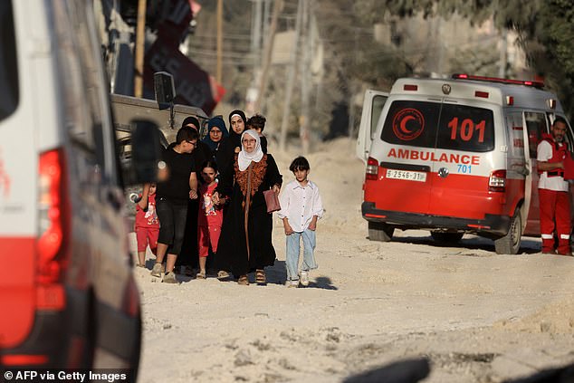 Members of a Palestinian family fleeing an Israeli raid on the Nur Shams camp near the town of Tulkarem