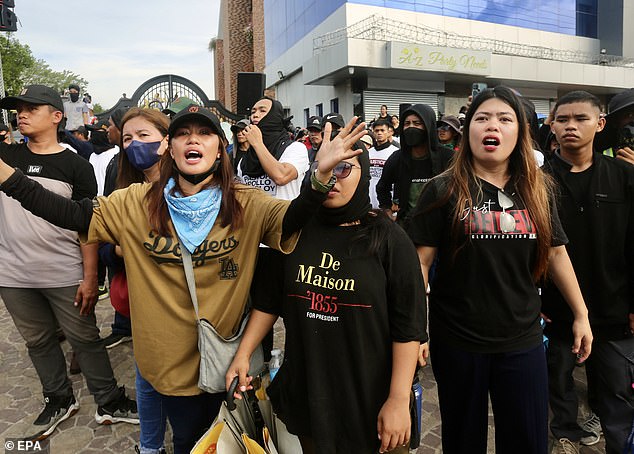 Supporters of religious leader Apollo Quiboloy hold a protest rally outside the complex