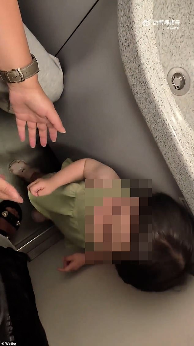 One of the two women, Gou Tingting, posted a video of herself carrying the toddler to the toilet on Chinese social media. She wrote in a comment to justify her actions: 'I just wanted to raise the child and give everyone a good night'