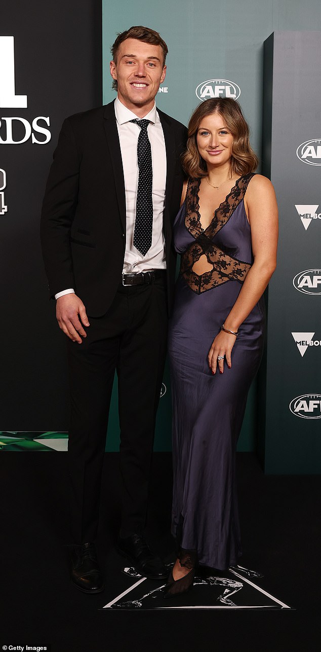 Blues star Patrick Cripps, 29, (left) smiled happily next to his partner Monique Fontana (right) who sparkled in a black satin and lace dress